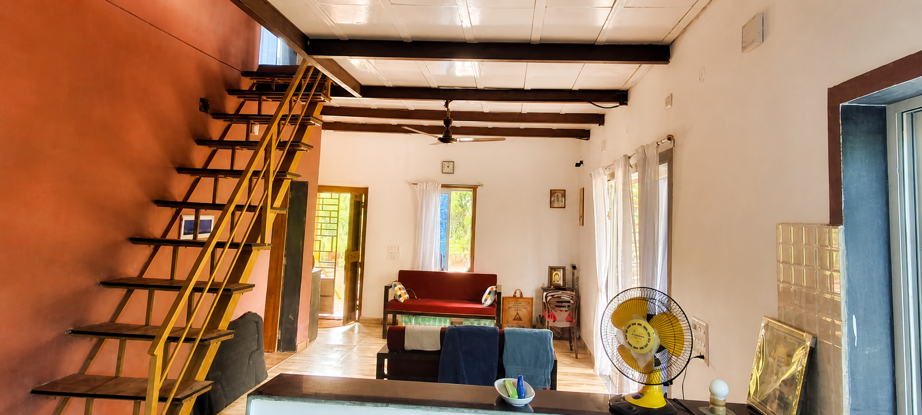 Spacious farmhouse living hall with staircase and windows