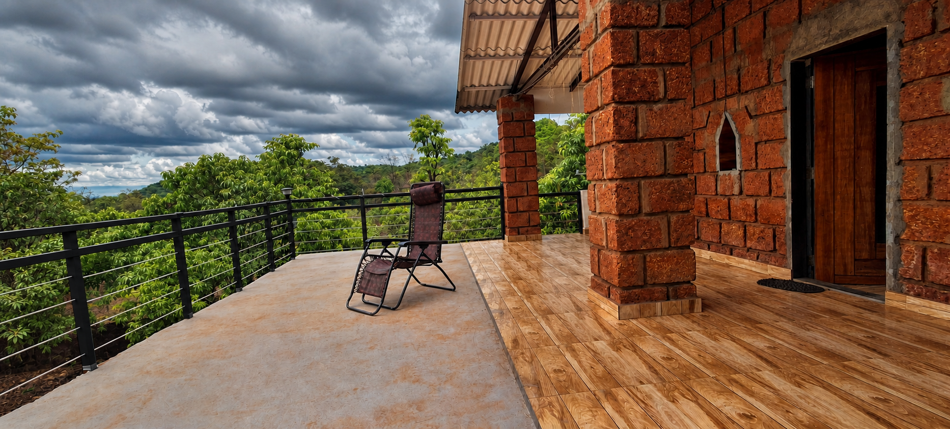 Spacious laterite terrace overlooking green hills beneath monsoon clouds
